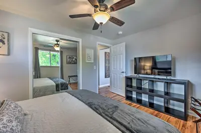 a bedroom with a bed and a flat screen tv at Fenced Yard and Patio Pet-Friendly Denver Home Base in Arvada