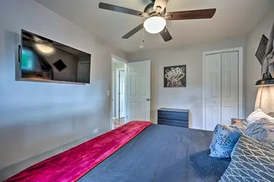 a bedroom with a large bed with a ceiling fan at Fenced Yard and Patio Pet-Friendly Denver Home Base in Arvada