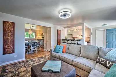 a living room with a couch and a kitchen at Fenced Yard and Patio Pet-Friendly Denver Home Base in Arvada
