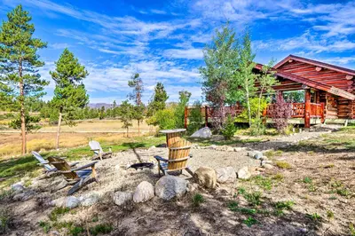 a log cabin with chairs and a table in the yard at Less Than 1 Mi to Lake Granby Log Cabin with Fire Pit in Grand Lake