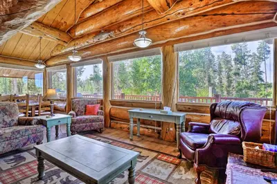a living room with couches and a table at Less Than 1 Mi to Lake Granby Log Cabin with Fire Pit in Grand Lake