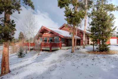 a log cabin in the snow with trees at Less Than 1 Mi to Lake Granby Log Cabin with Fire Pit in Grand Lake