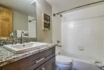 a bathroom with a sink and a toilet and a tub at 7 Mi to Keystone Waterfront Home with Scenic Views in Silverthorne