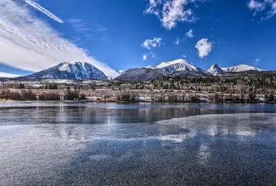 a body of water with snow capped mountains in the background at 7 Mi to Keystone Waterfront Home with Scenic Views in Silverthorne