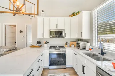 a kitchen with white cabinets and a stove top oven at Romantic Mountain Retreat with Scenic Views! in Idaho Springs
