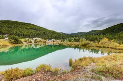 a river in the middle of a valley with trees at Romantic Mountain Retreat with Scenic Views! in Idaho Springs