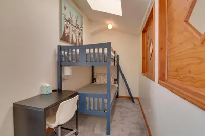 a room with a desk and a bunk bed at Balcony and Ski Slope Views Idyllic Granby Condo! in Granby