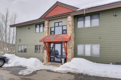 a house with a door with snow around it at Balcony and Ski Slope Views Idyllic Granby Condo! in Granby