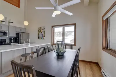 a kitchen and dining room with a table and chairs at Balcony and Ski Slope Views Idyllic Granby Condo! in Granby