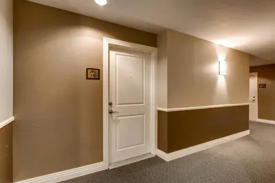 a hallway with a white door and a shelf at Mountain Views Luxury Condo in the DTC in Centennial