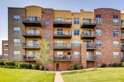 an apartment building with balconies and a lawn at Mountain Views Luxury Condo in the DTC in Centennial