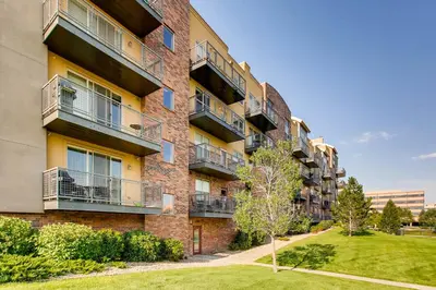 an apartment building with balconies and a yard at Mountain Views Luxury Condo in the DTC in Centennial