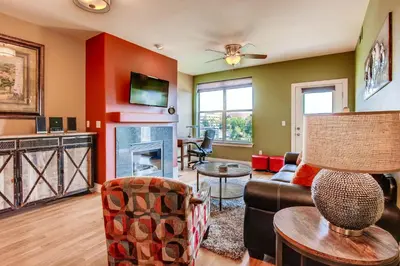 a living room with a couch and a fireplace at Mountain Views Luxury Condo in the DTC in Centennial