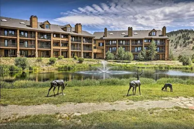 three gazelles grazing in a field in front of a hotel at Relax, Adventure, Views, Amenities+Memories (Full) in Granby
