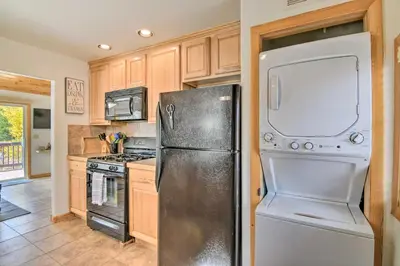 a kitchen with a refrigerator and a stove at 4 Mi to Grand Lake Mtn-View Cabin with Fire Pit! in Grand Lake