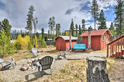 a group of chairs in a yard with a building at 4 Mi to Grand Lake Mtn-View Cabin with Fire Pit! in Grand Lake