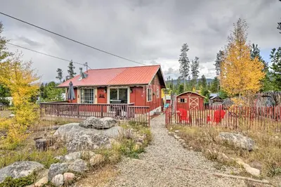 a red house with a red roof at 4 Mi to Grand Lake Mtn-View Cabin with Fire Pit! in Grand Lake