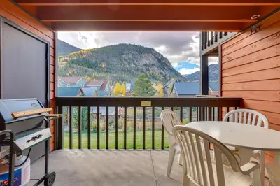 a balcony with a table and chairs and a view of a mountain at Walkable Frisco Condo Mtn Views and Shared Hot Tub! in Frisco