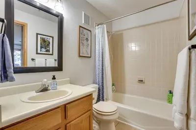 a bathroom with a sink and a toilet and a tub at Walkable Frisco Condo Mtn Views and Shared Hot Tub! in Frisco