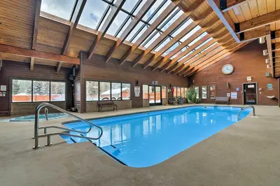 a large swimming pool in a building with a ceiling at Walkable Frisco Condo Mtn Views and Shared Hot Tub! in Frisco