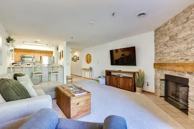 a living room with a couch and a fireplace at Walkable Frisco Condo Mtn Views and Shared Hot Tub! in Frisco
