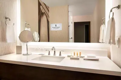 a bathroom with a sink and a large mirror at Renaissance Denver Downtown City Center Hotel in Denver
