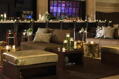 a living room with two couches and a bar at Renaissance Denver Downtown City Center Hotel in Denver