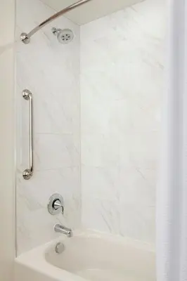 a white bathroom with a shower and a sink at Renaissance Denver Downtown City Center Hotel in Denver