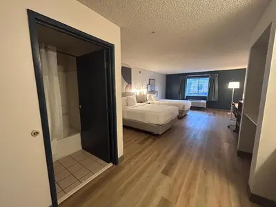 a bedroom with a bed and a couch in a room at Quality Inn Denver Tech Center in Englewood