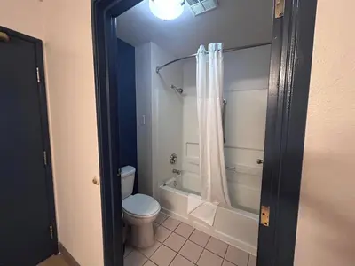 a bathroom with a toilet and a tub and a shower at Quality Inn Denver Tech Center in Englewood