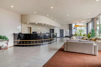 a lobby with a couch and a bar in a building at Inn at the Highland Denver Downtown in Denver