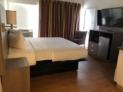 a hotel room with a bed and a television at Inn at the Highland Denver Downtown in Denver
