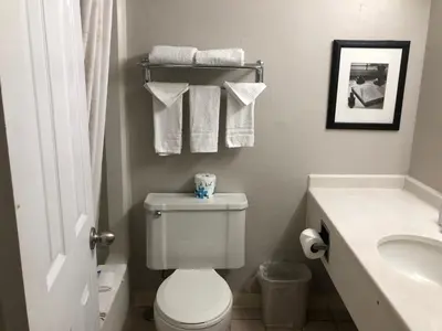 a bathroom with a toilet and a sink and towels at Inn at the Highland Denver Downtown in Denver