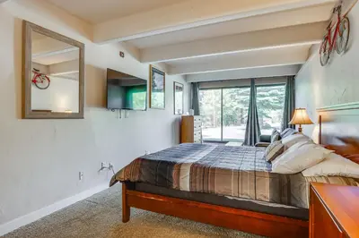 a bedroom with a bed and a mirror and a window at Lakefront Condo with Mtn Views in Dillon! in Dillon