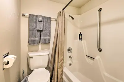 a white bathroom with a toilet and a shower at Lakefront Condo with Mtn Views in Dillon! in Dillon