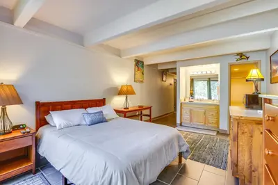 a bedroom with a large bed and a kitchen at Lakefront Condo with Mtn Views in Dillon! in Dillon