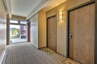 a hallway with two doors and a window at Lakefront Condo with Mtn Views in Dillon! in Dillon
