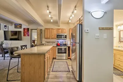 a kitchen with wooden cabinets and a refrigerator at Lakefront Condo with Mtn Views in Dillon! in Dillon