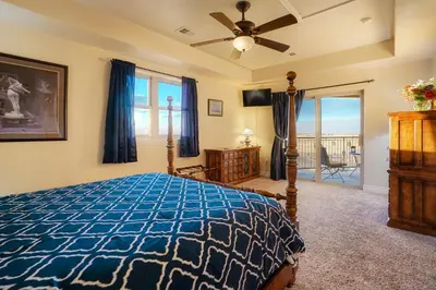 a bedroom with a bed and a ceiling fan at Summit Villa BnB in Watkins