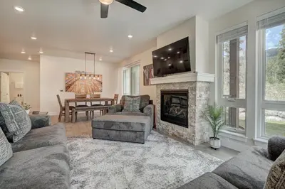 a living room with a fireplace and a tv at Brand New Clear Water Lofts - 2br Premier Condo - Kids Ski Free! condo in Keystone