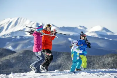 a group of three people holding skis on a snow covered slope at Brand New Clear Water Lofts - 2br Premier Condo - Kids Ski Free! condo in Keystone