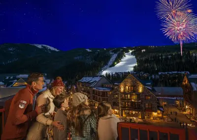 a group of people standing on a balcony looking at fireworks at Brand New Clear Water Lofts - 2br Premier Condo - Kids Ski Free! condo in Keystone