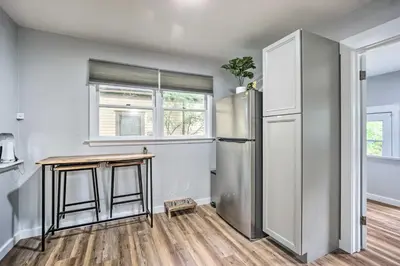 a kitchen with a refrigerator and a table at Charming Fort Collins Home By Old Town and CSU! in Fort Collins