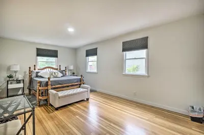 a bedroom with a bed and a wooden floor at Charming Fort Collins Home By Old Town and CSU! in Fort Collins