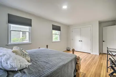a bedroom with a bed and two windows at Charming Fort Collins Home By Old Town and CSU! in Fort Collins