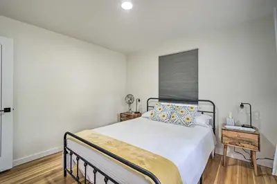 a bedroom with a large bed and a window at Charming Fort Collins Home By Old Town and CSU! in Fort Collins