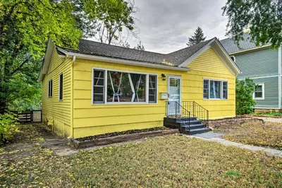 a yellow house with a yard at Charming Fort Collins Home By Old Town and CSU! in Fort Collins
