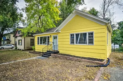 a yellow tiny house with a driveway at Charming Fort Collins Home By Old Town and CSU! in Fort Collins