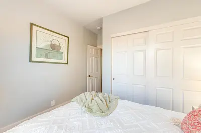 a bedroom with a white door and a bed at Furnished Patio and Yard Denver Bungalow! in Denver