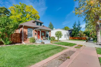 a house with a lawn and a sidewalk at Furnished Patio and Yard Denver Bungalow! in Denver